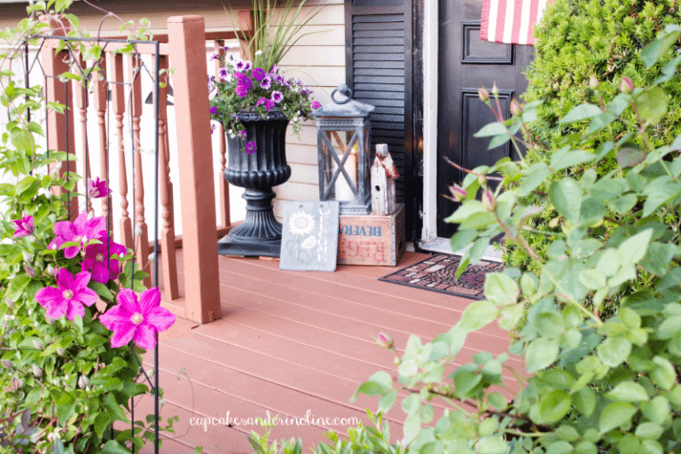 Front porch decor ~ lantern with candle on a vintage soda pop box with an old wooden church from cupcakesandcrinoline.com