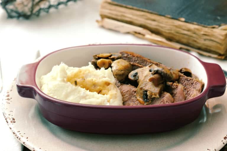 Beef roast in a fresh rosemary and mushroom sauce with homemade mashed potatoes.