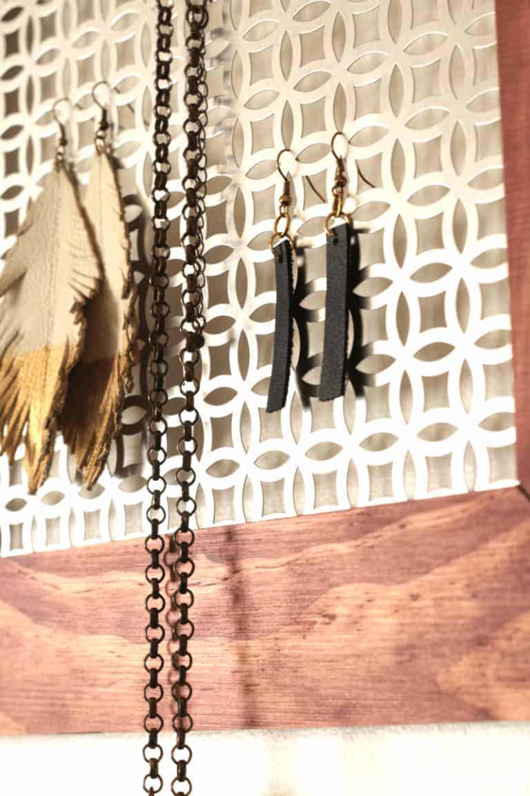 DIY leather earrings and white feather earrings dipped in gold and black leather dangle drop earrings. Get the tutorial at www.cupcakesandcrinoline.com