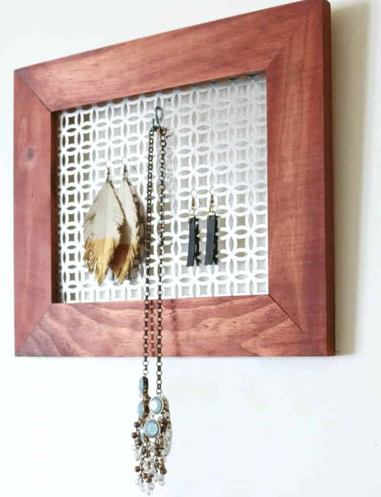 DIY Jewelry Wall organizer on wall with jewelry - get the tutorial at www.cupcakesandcrinoline.com