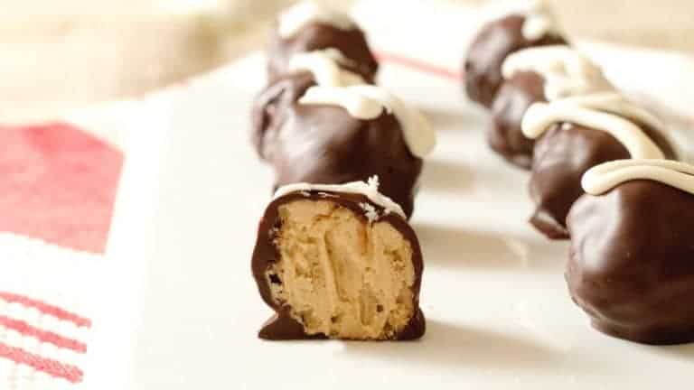 Chocolate Covered Peanut Butter Balls with Rice Krispies. These smooth and creamy chocolate-covered peanut butter balls with Rice Krispies are a hit at every party and so easy to make! Get the recipe at www.cupcakesandcrinoline.com