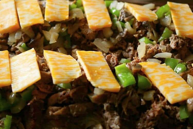Sliced cheese on sauteed onions, green peppers, mushrooms, and fried steak on French Bread.