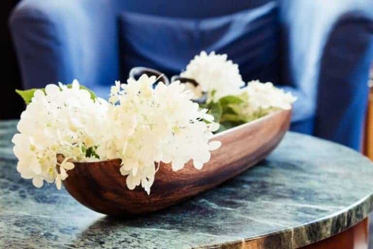 Farmhouse style hydrangea display in wooden bowl with vintage garden clippers