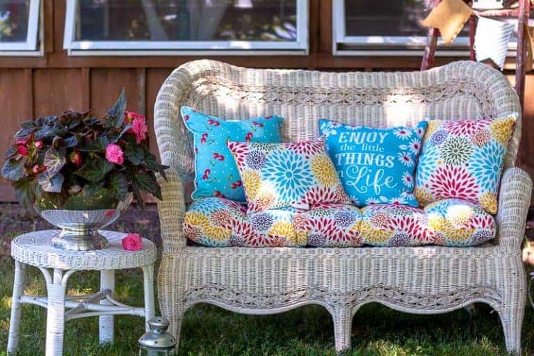 White wicker sofa with colorful cushions and pillows