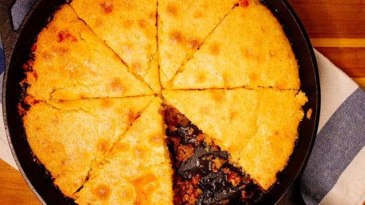 Beef Tamale Pie topped with cornbread in a cast iron skillet fresh out of the oven