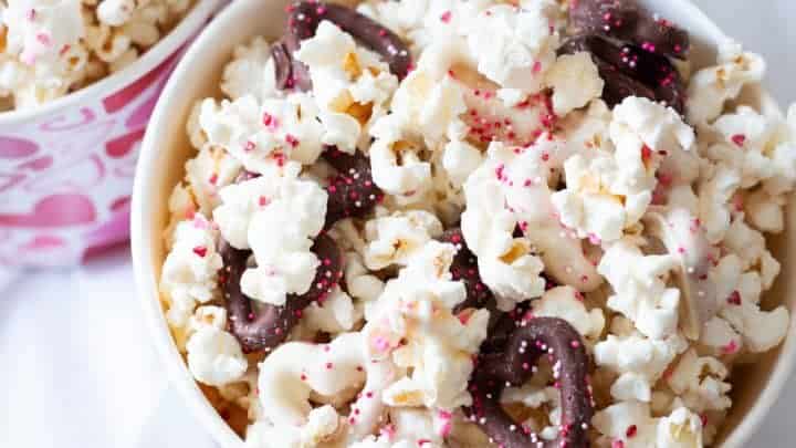 Overhead view of white chocolate popcorn in a popcorn pail