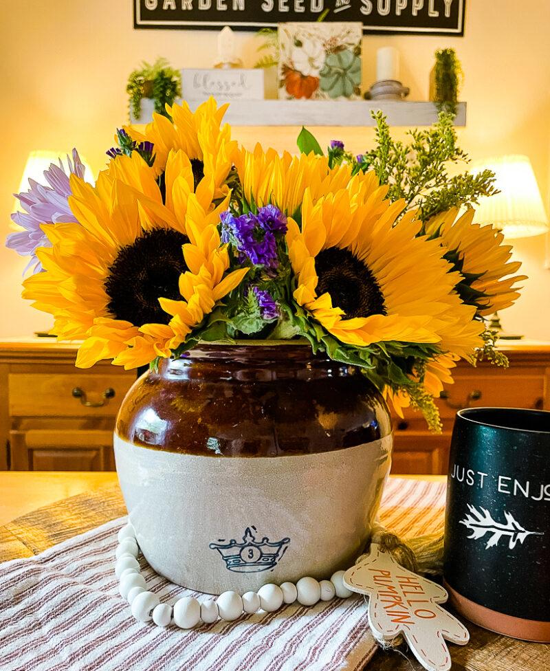 https://thehowtohome.com/wp-content/uploads/2021/09/Vintage-Bean-Pot-Filled-with-a-Sunflower-Bouquet-800x976.jpg