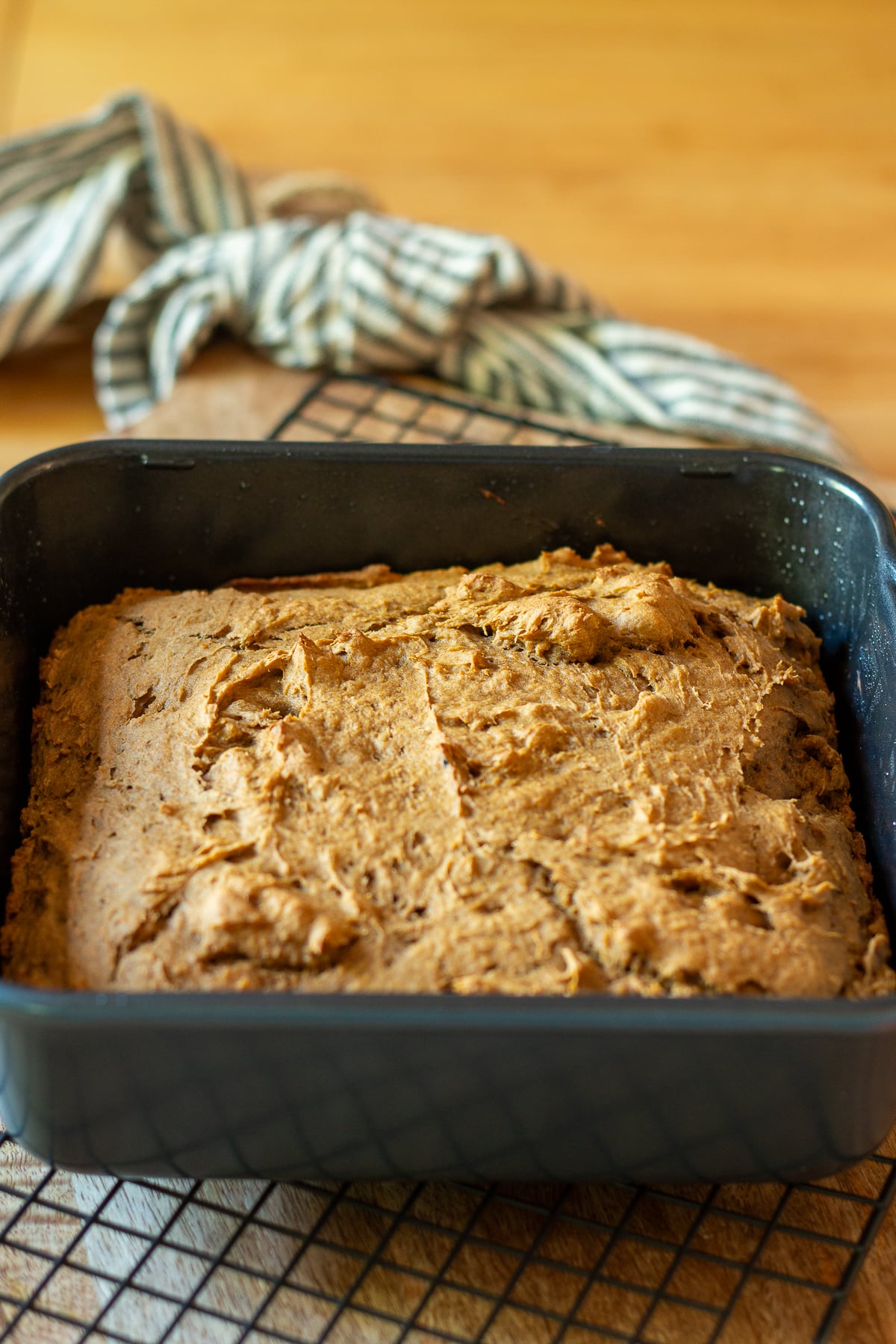 2 ingredient pumpkin cake sliced and cooling on a wire rack