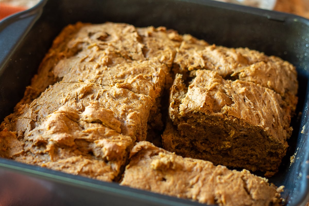 2 ingredient pumpkin cake cut into pieces in the baking pan