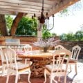 beautiful outdoor seating with a chandelier and outdoor kitchen
