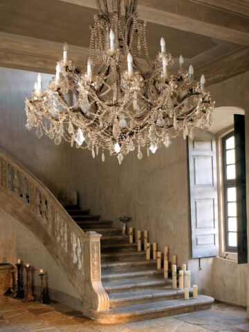 Lovely large ornate chandelier in the entry hall of a modern day mansion