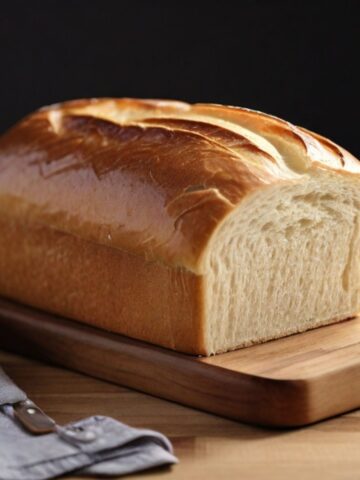 Freshly baked bread with a slice cut off the end