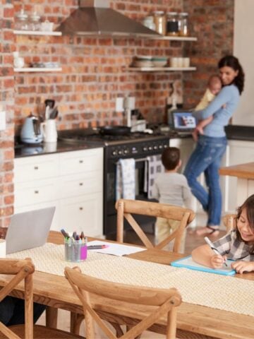 Family spending quality time in a modern kitchen, highlighting everyday exposure risks without asbestos testing.
