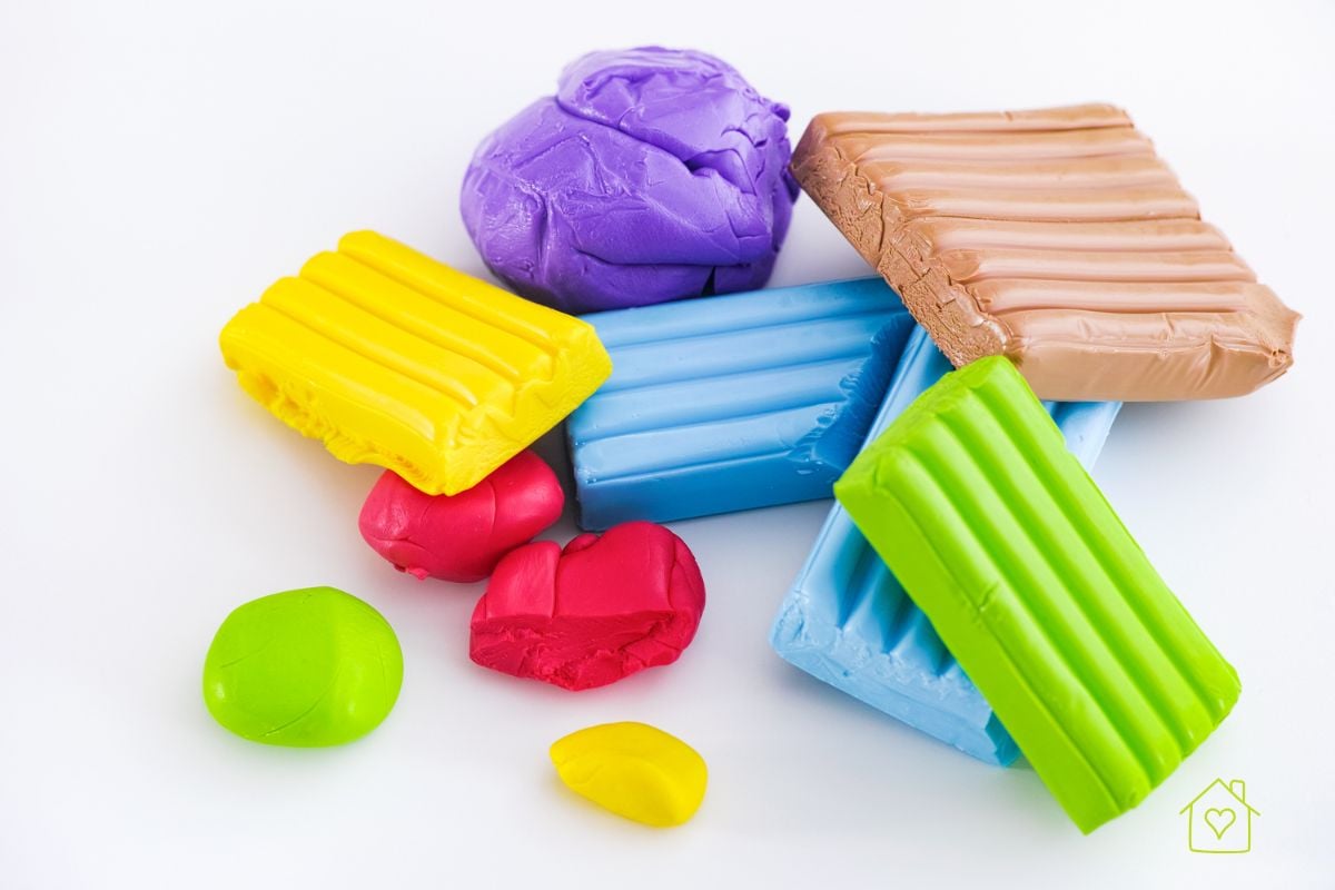 A variety of colorful polymer clay blocks in yellow, blue, green, purple, tan, and red displayed on a white background, ideal for beginners exploring different brands.