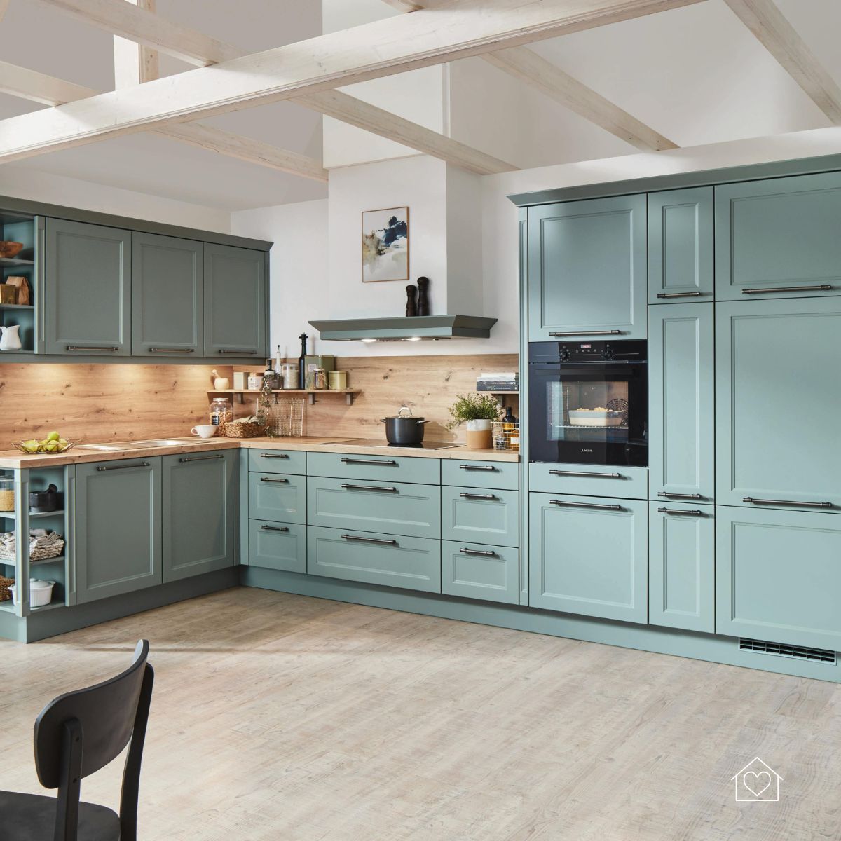 A bright kitchen with newly refaced teal cabinets, wood backsplash, and open shelving that showcases a fresh, modern farmhouse style.