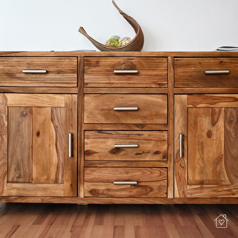 Close-up of a handcrafted sideboard made from reclaimed wood with metal handles, showcasing a rustic and eco-friendly furniture option.