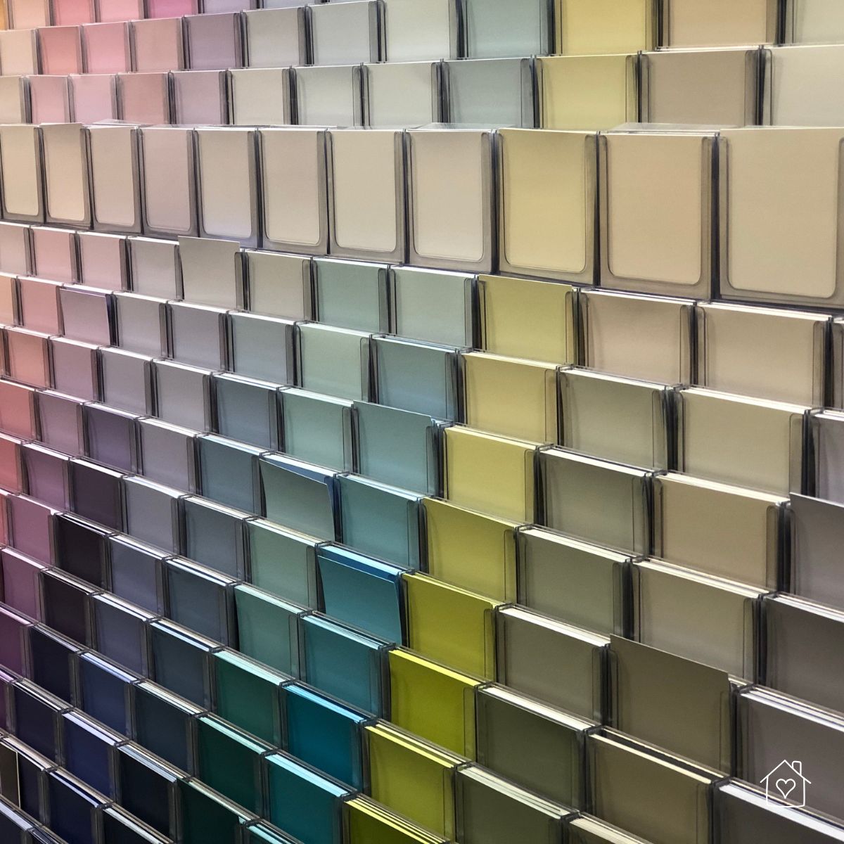 A full wall of paint swatches in a gradient of colors, showcasing options for customizing your home’s color palette to suit your style.