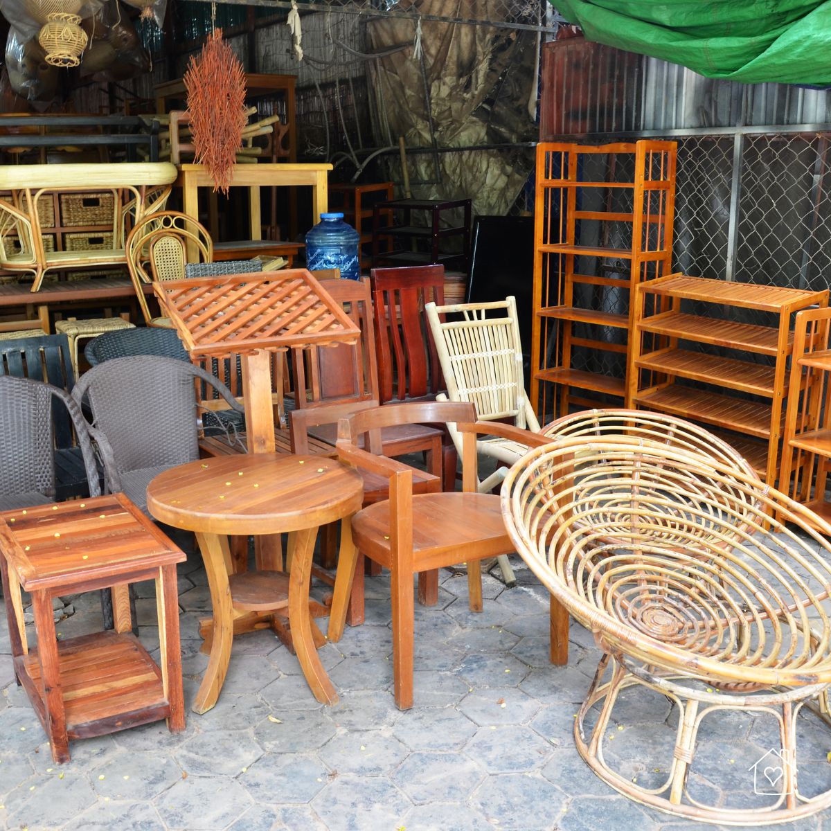 A variety of pre-loved wooden chairs, tables, and shelves displayed at a secondhand market, ideal for sustainable and affordable home redecorating.