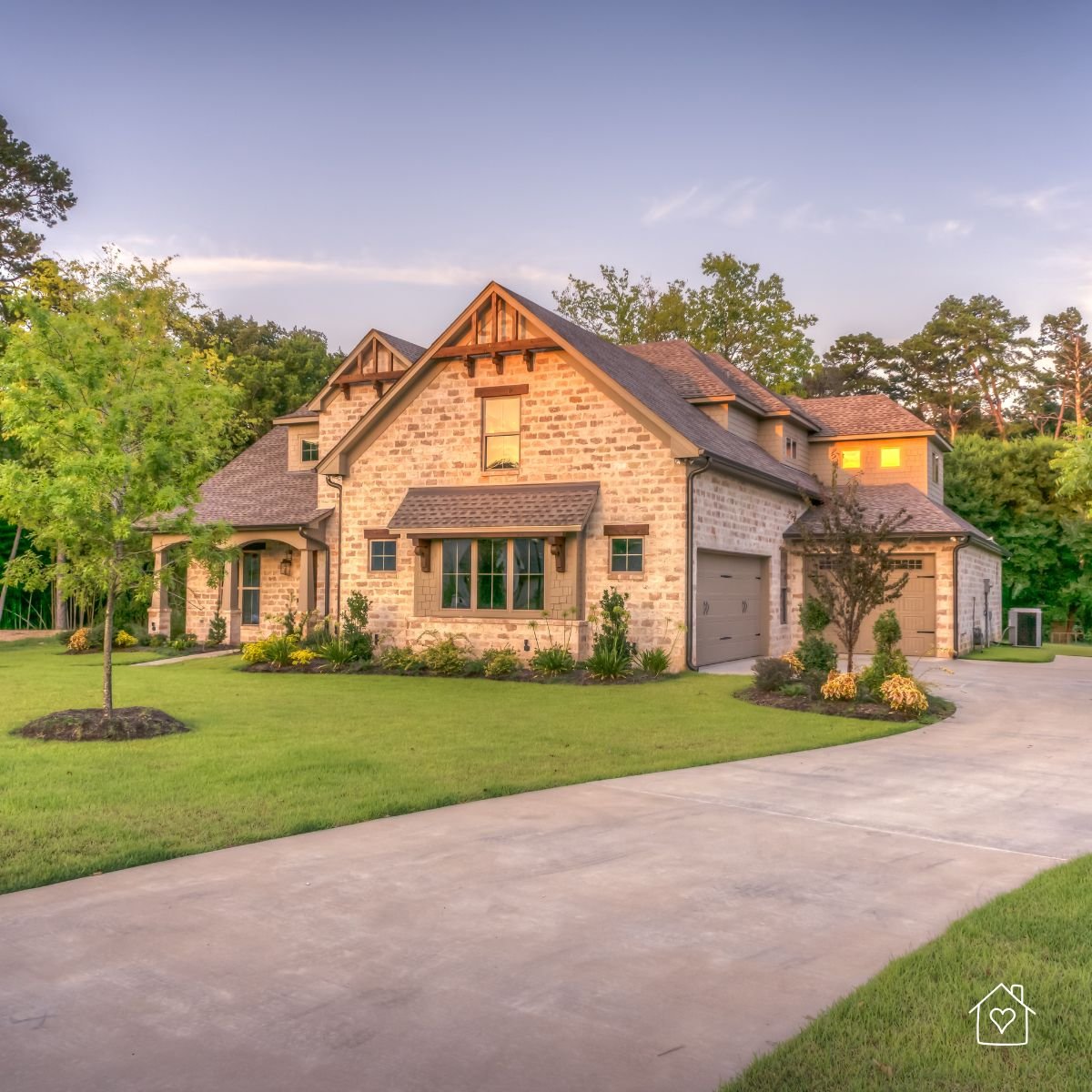 Beautiful two-story stone house with a well-kept lawn, showcasing the results of completed emergency home maintenance.