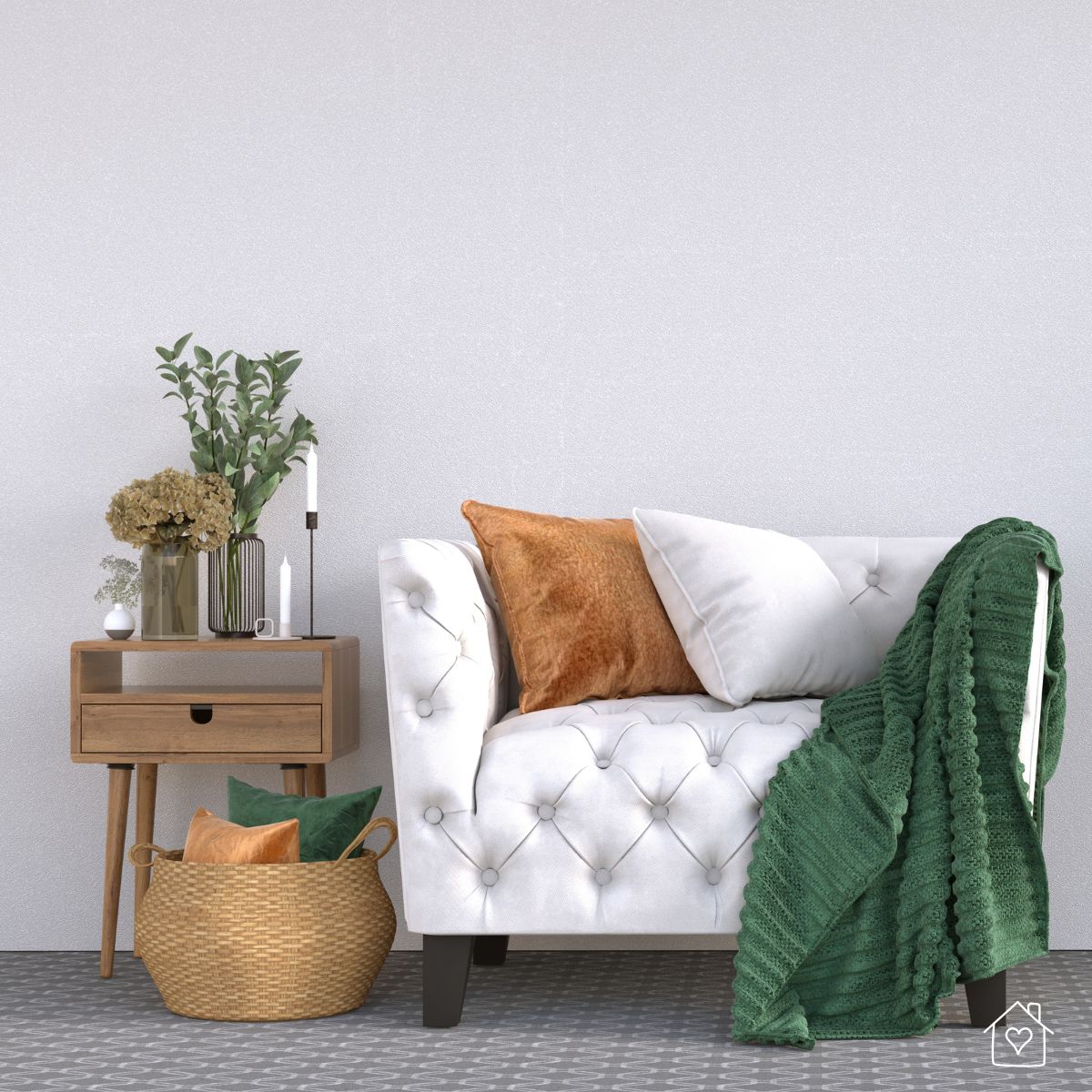 Simple yet cozy home decor setup with a tufted chair, colorful pillows, a green throw blanket, and a wooden side table with a vase of greenery.