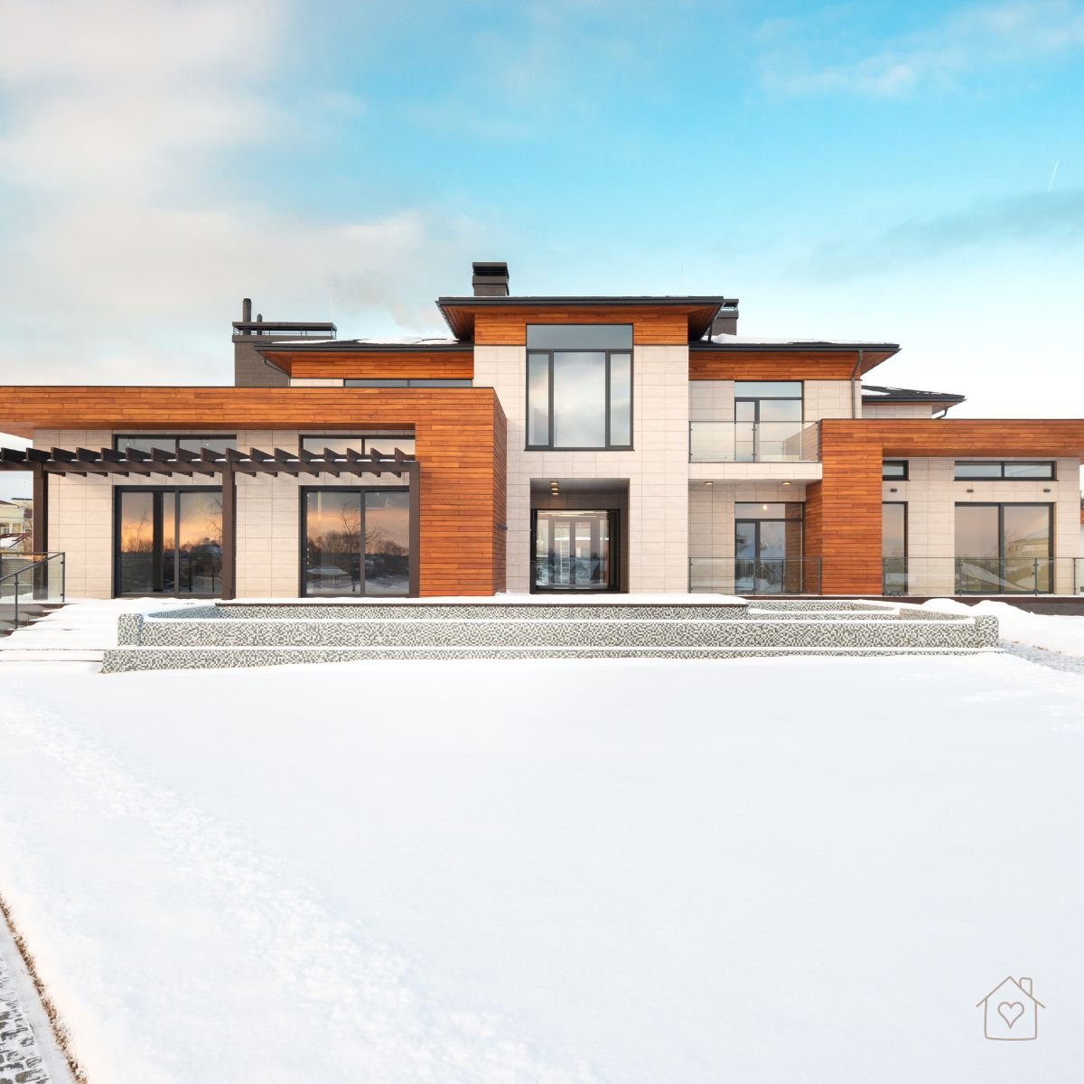 Modern Australian house exterior showcasing warm timber cladding and concrete finishes, blending texture and natural tones.