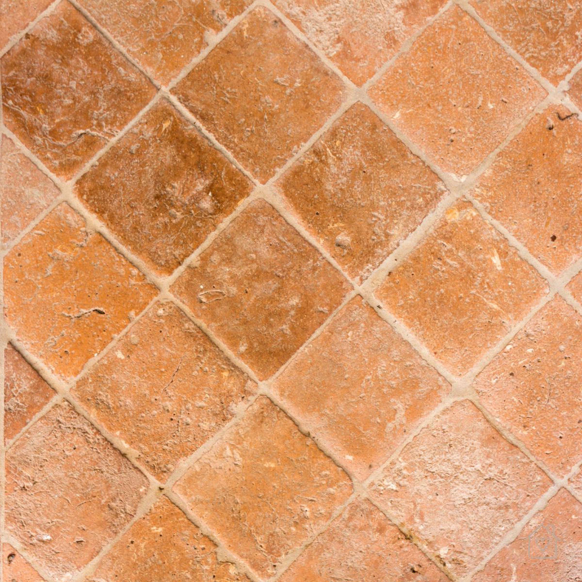 Textured terracotta tiles arranged in a diamond pattern, highlighting earthy tones used in modern Australian homes.