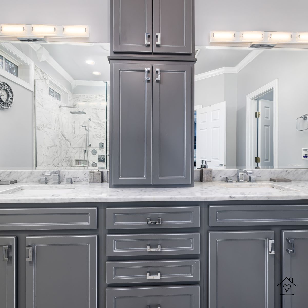 Elegant gray bathroom cabinets with polished chrome pulls and marble countertop.