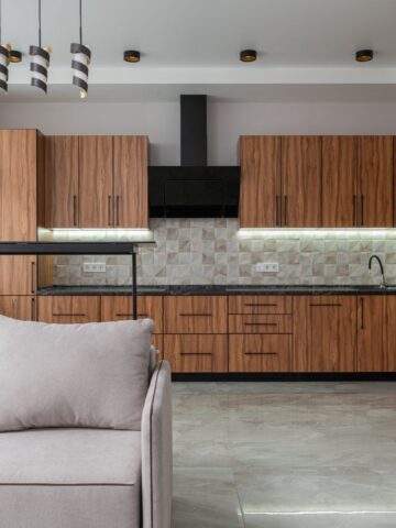 Modern wood cabinets with sleek black pulls in a contemporary open kitchen design.