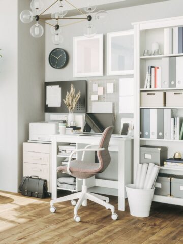 Minimal home office with ergonomic chair, compact desk, pegboard, and tall shelving for files and bins.