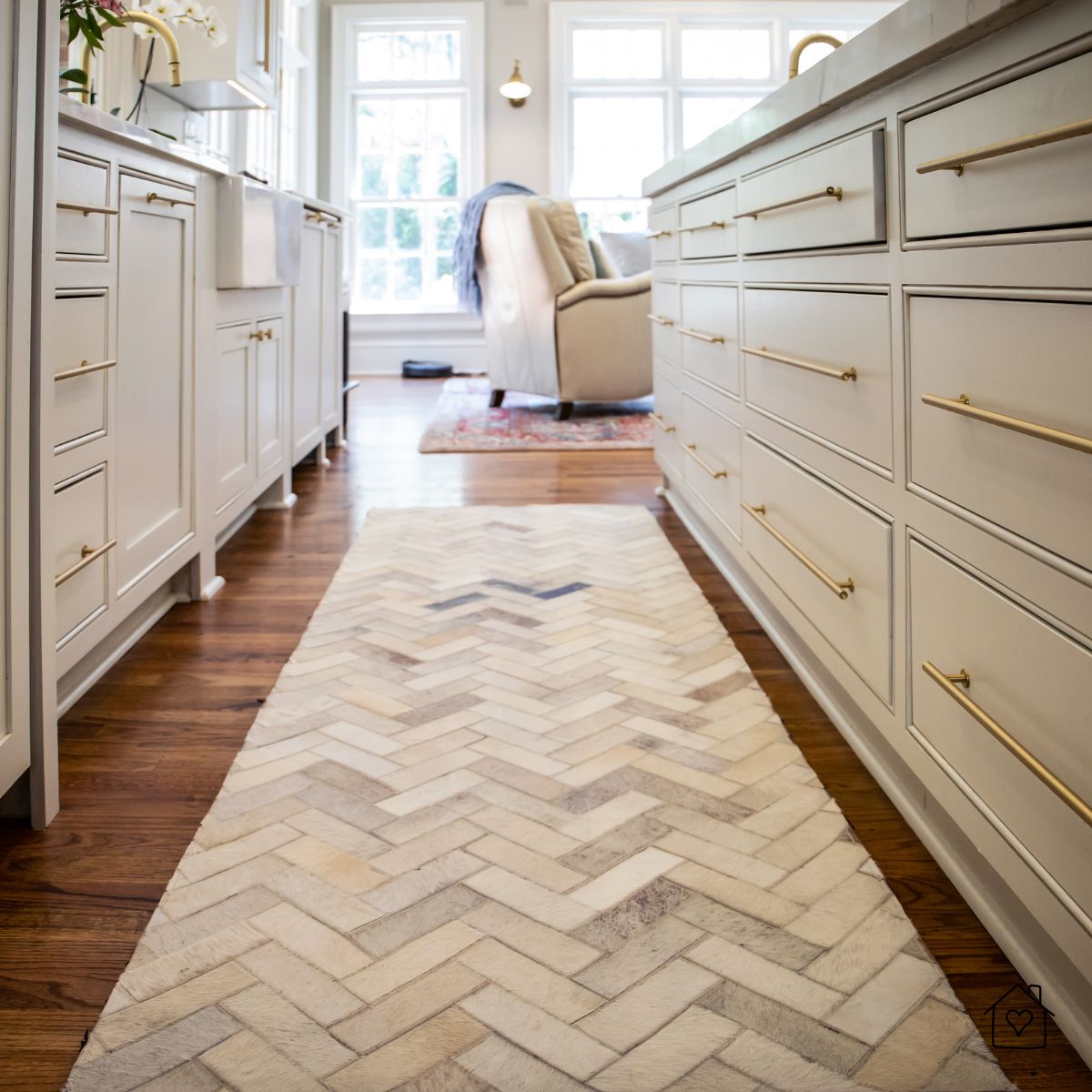 Chevron-patterned runner rug placed between kitchen cabinets over hardwood floors.