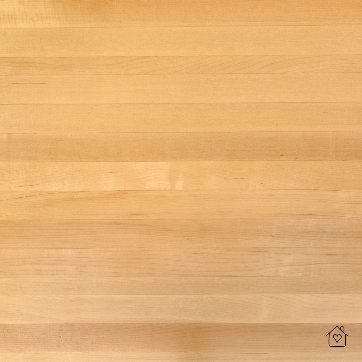 Smooth edge-grain maple butcher block with pale, uniform color.