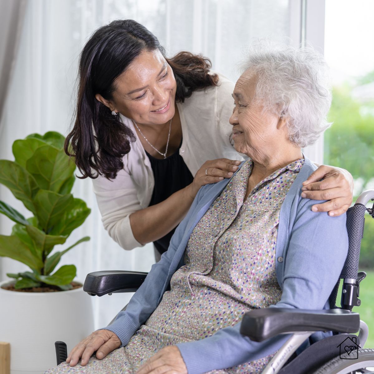 Caregiver offering gentle support to a woman in a wheelchair, representing personalized daily assistance and dignified care in nursing facilities.