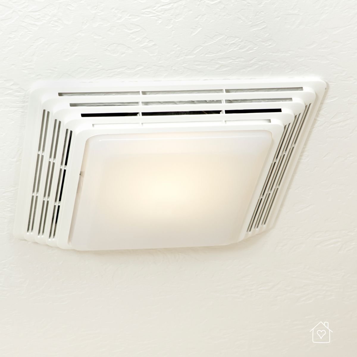 Ceiling-mounted exhaust fan with built-in light, designed to ventilate moisture and prevent mold in bathrooms.