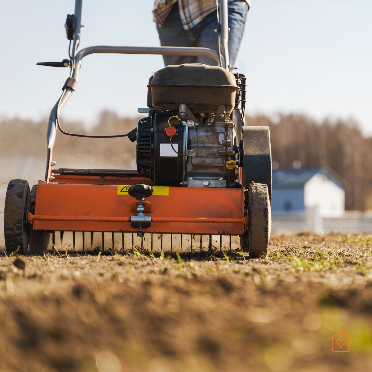Walk-behind core aerator pulling soil plugs from a lawn.
