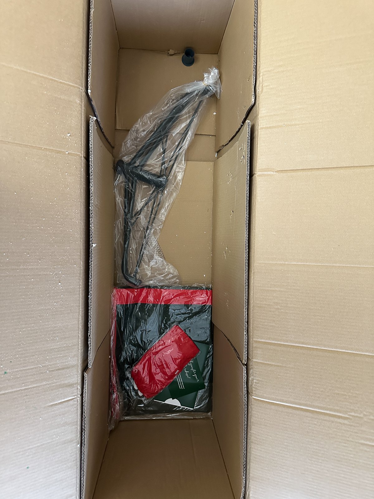 Tree stand, storage bag, and instructions inside the shipping box.