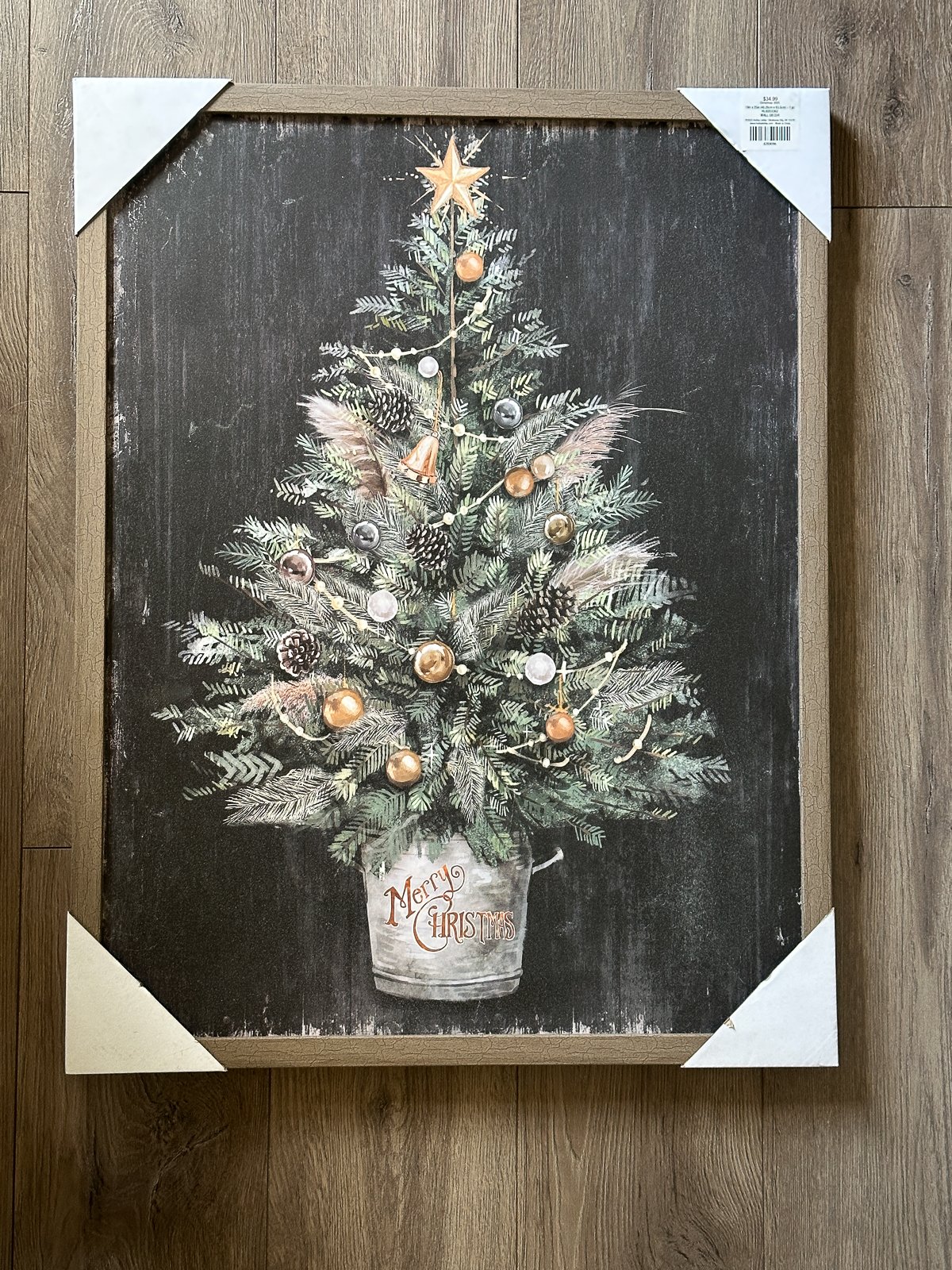 Vintage-style Christmas tree painting in a galvanized bucket with bronze ornaments.