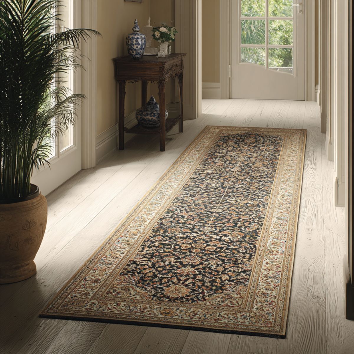 Dark patterned traditional runner rug in a minimalist hallway connecting bright adjoining rooms.