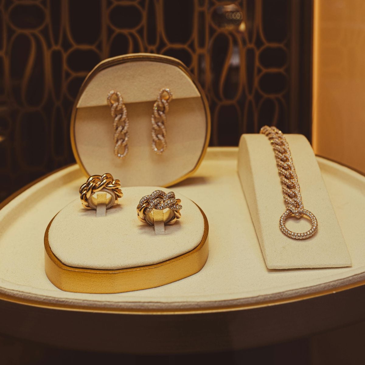 Gold rings, bracelet, and earrings displayed in a boutique—luxury pieces to insure and document.