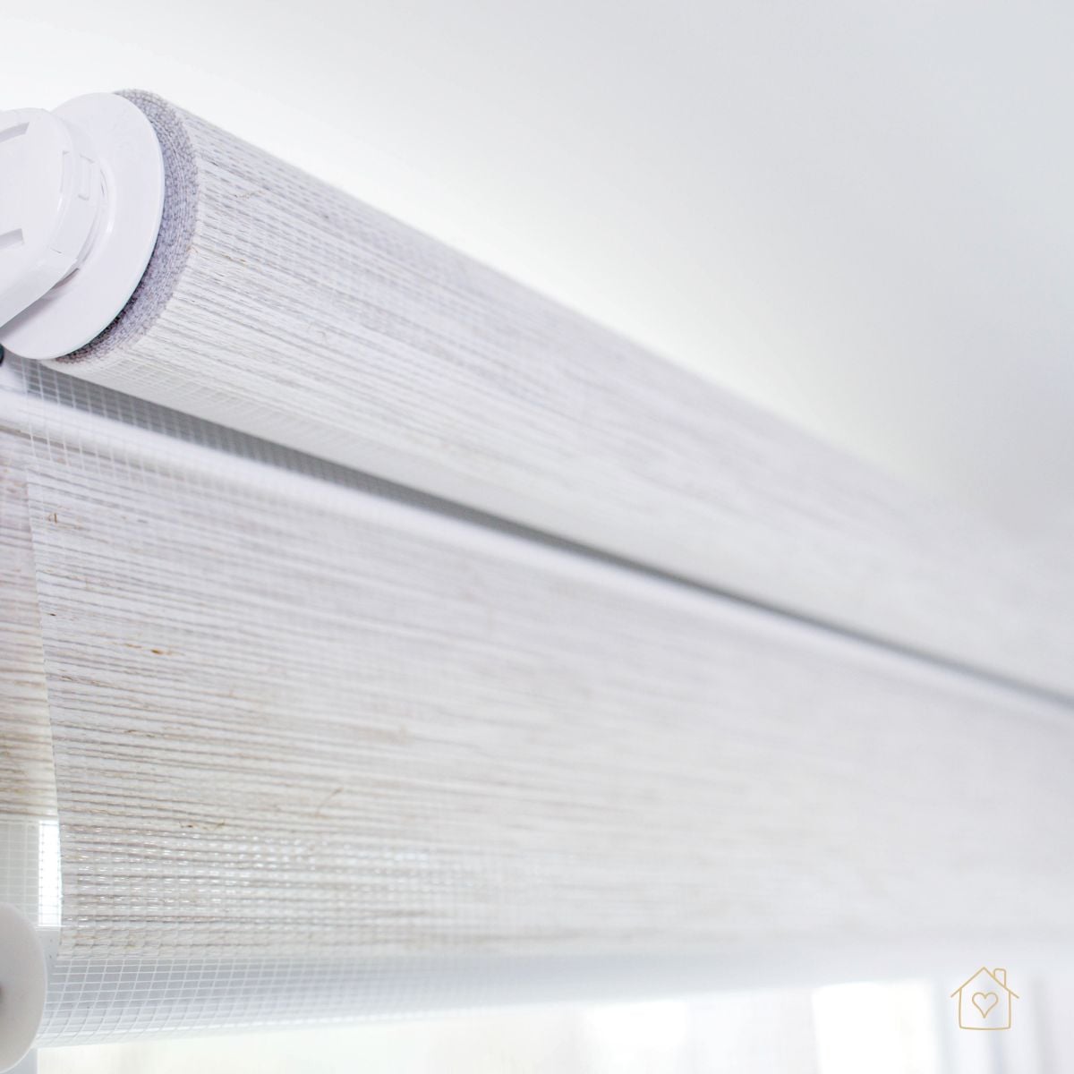 Detail of dual roller shade tubes with textured light-filtering fabric