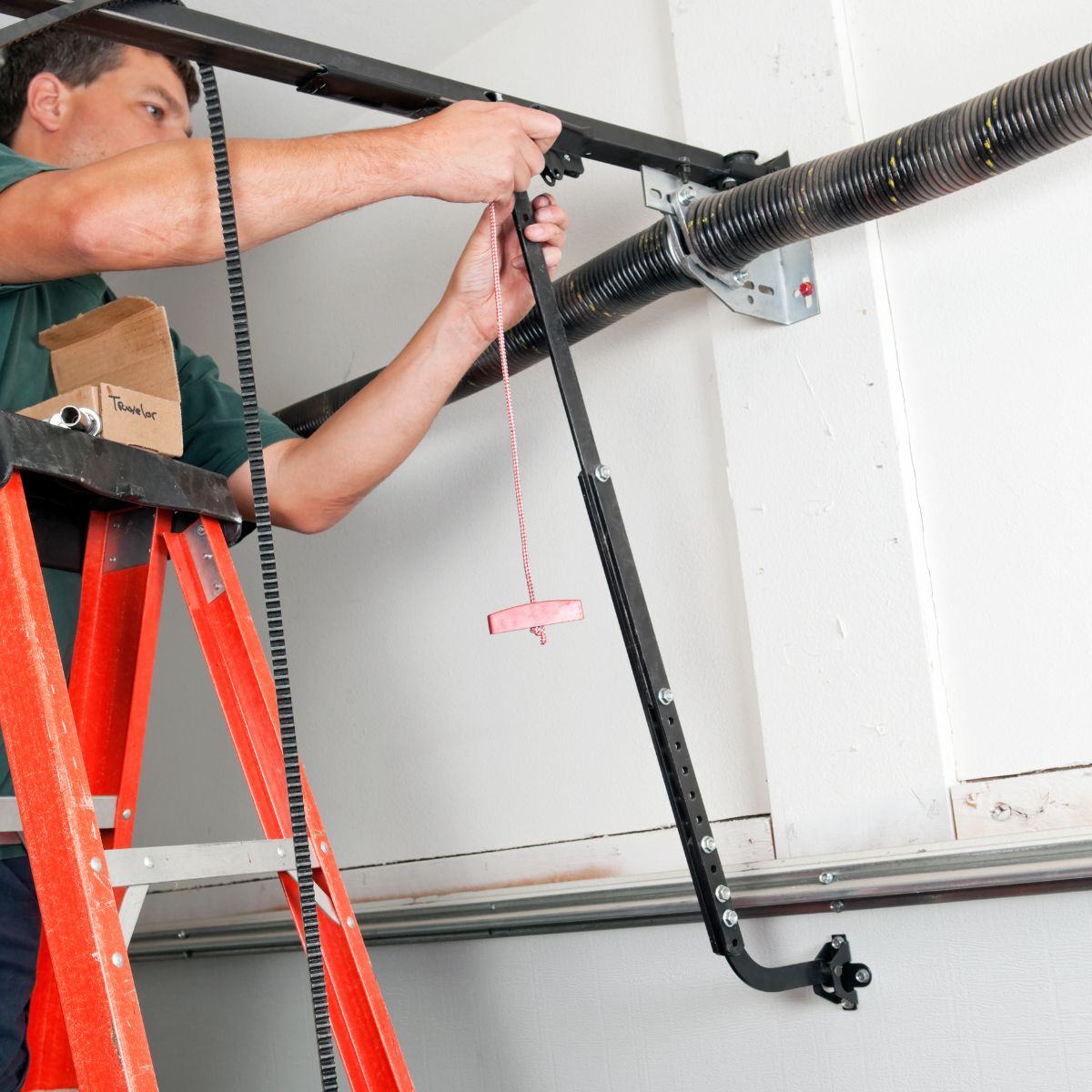 Technician on ladder adjusting opener linkage near torsion spring—work best left to pros