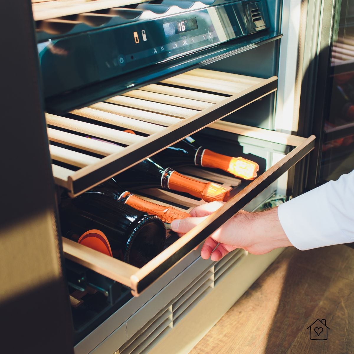 Hand pulling a wine fridge shelf with temperature display, showing how small setting issues affect stored bottles.