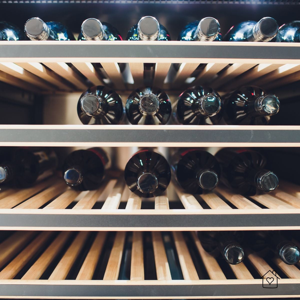 Close-up of wine bottles on ventilated wooden shelves that promote even airflow across the cellar.