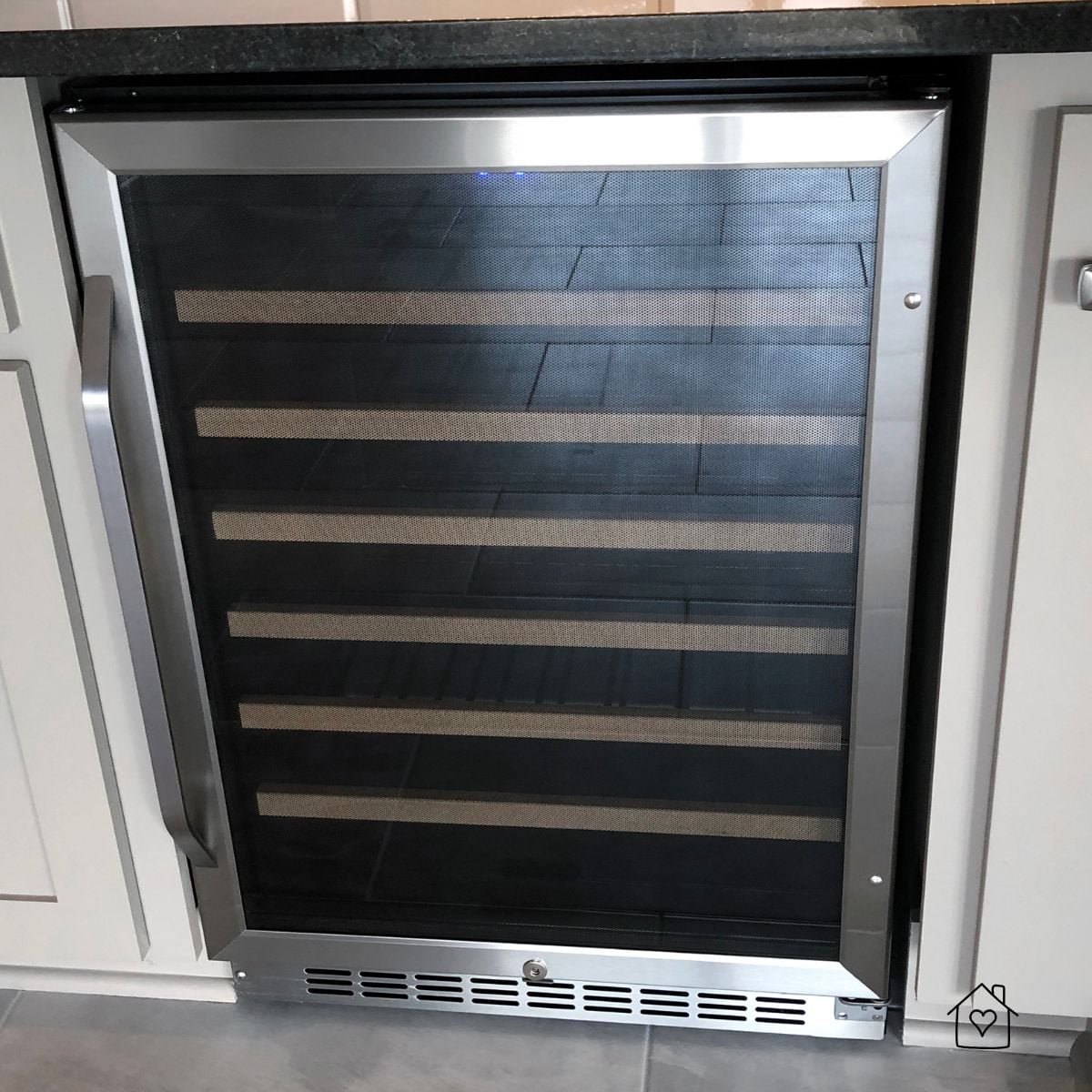 Undercounter wine cooler with front vent—common area for dust buildup, blocked airflow, and cooling faults.