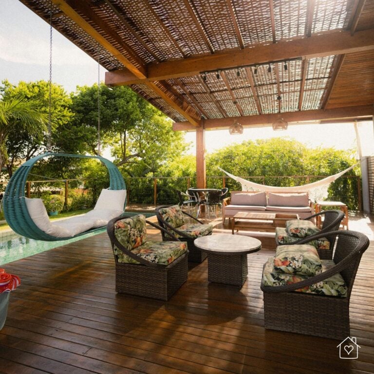covered wooden deck with pergola, seating area, and filtered sunlight