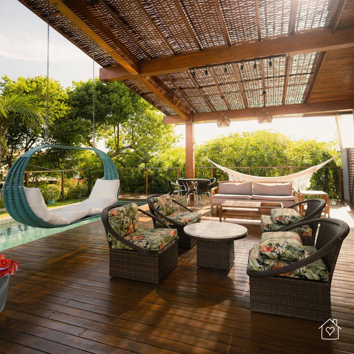 covered wooden deck with pergola, seating area, and filtered sunlight