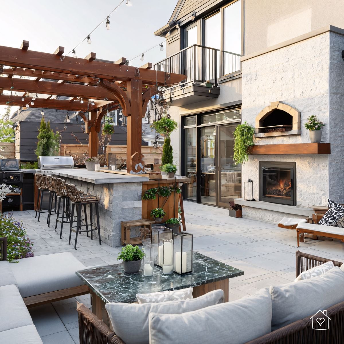 Modern outdoor kitchen with wood-fired pizza oven and built-in fireplace showing areas sealed with heat-resistant cement