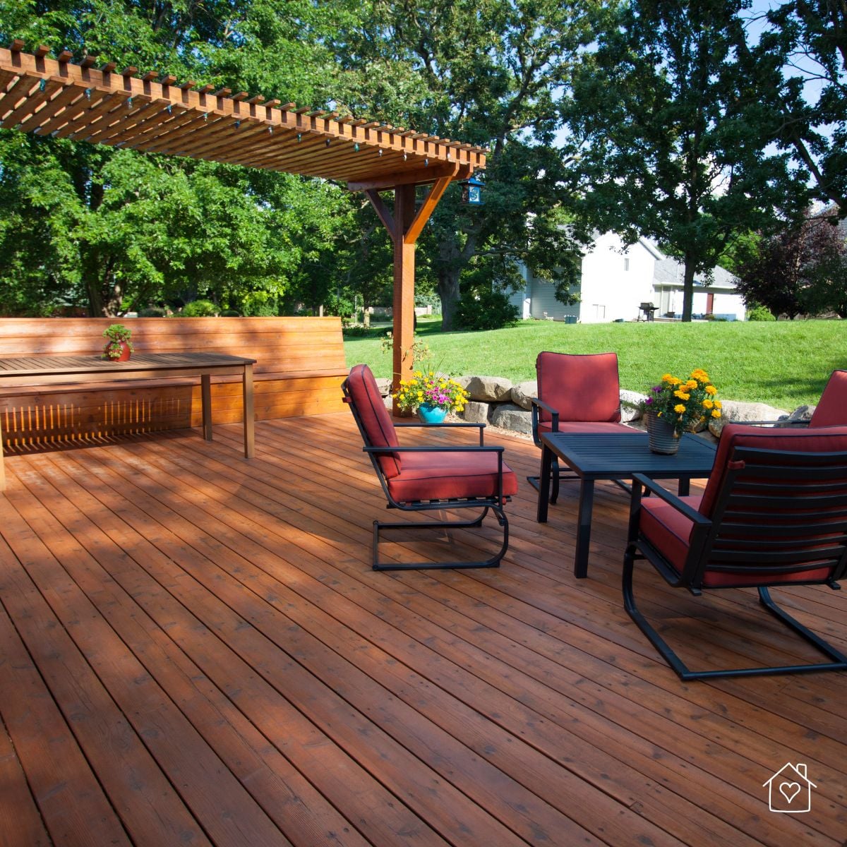backyard deck with pergola, seating area, and open lawn