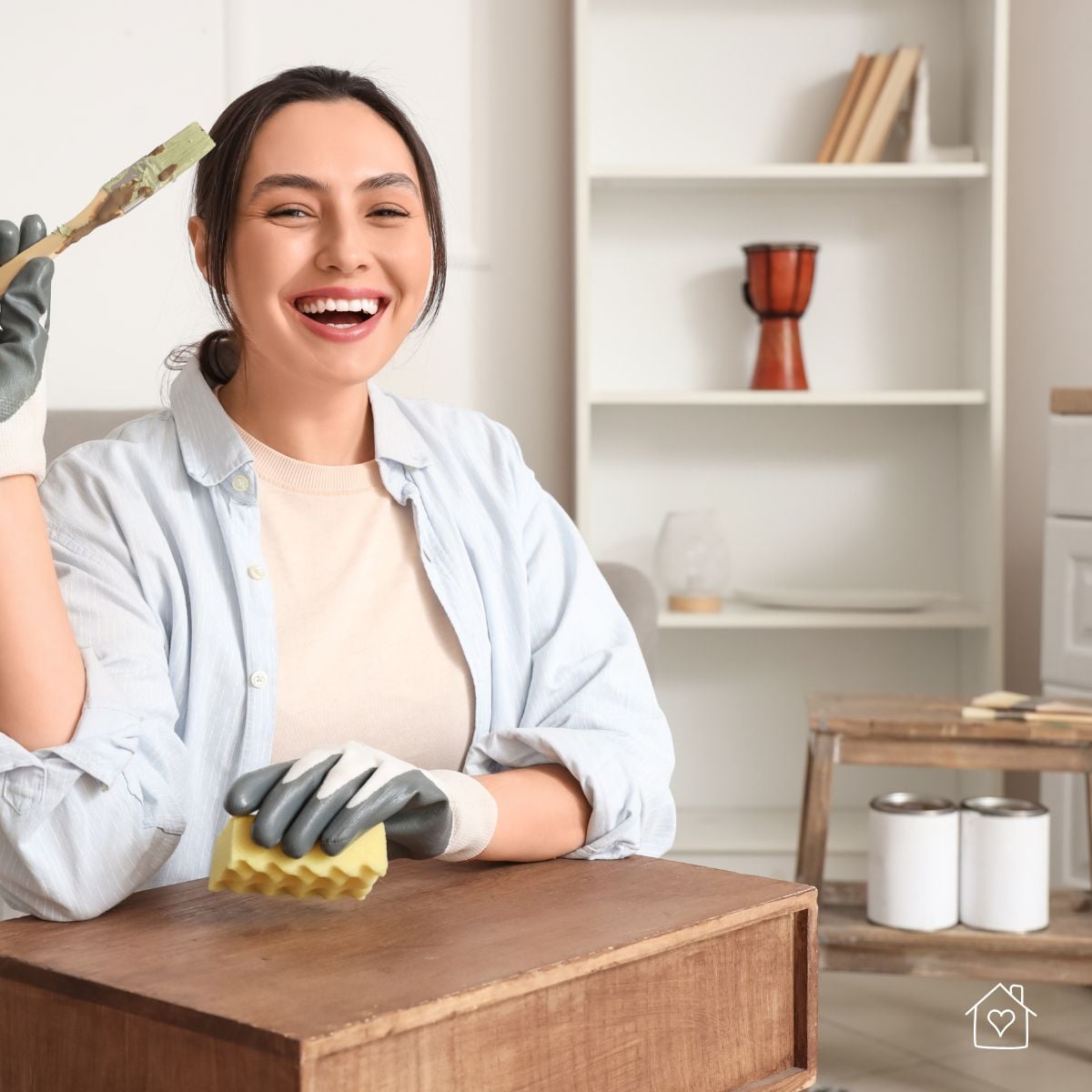 Preparing thrifted wood furniture with cleaning sponge and gloves before repairs and paint.