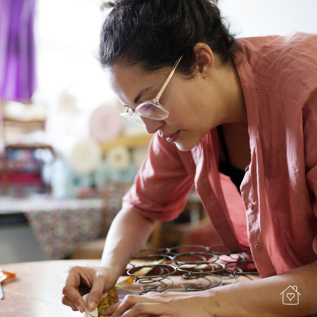 Repairing chair seat support by inspecting and tying coil springs during upholstery.
