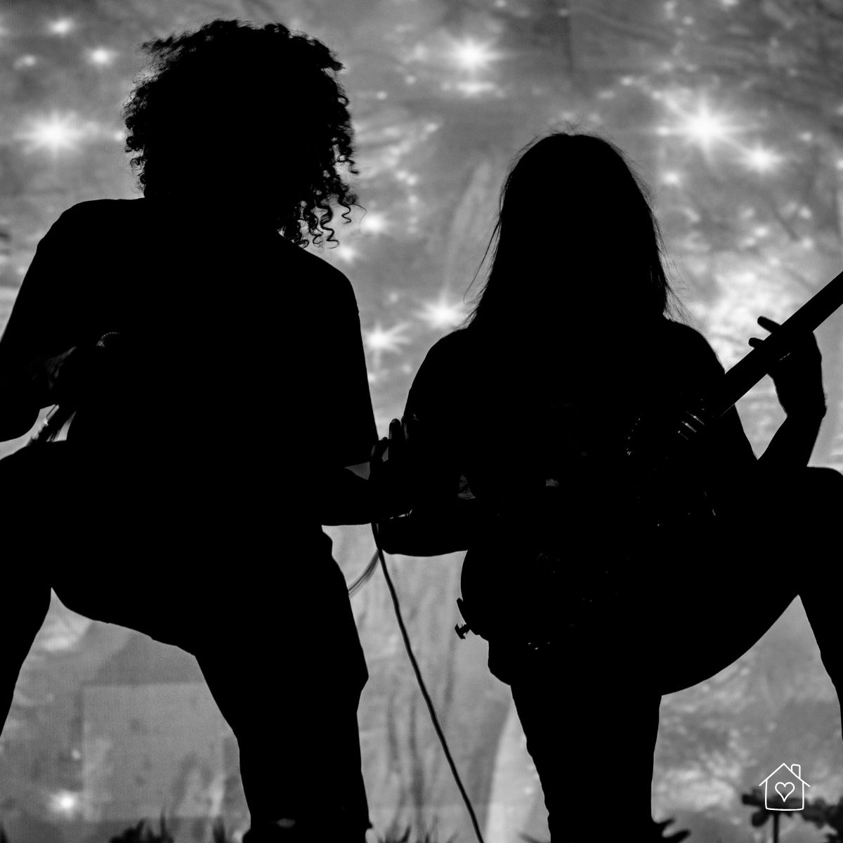 dramatic black and white silhouette of two people with instruments creating a grunge-style photoshoot look at home